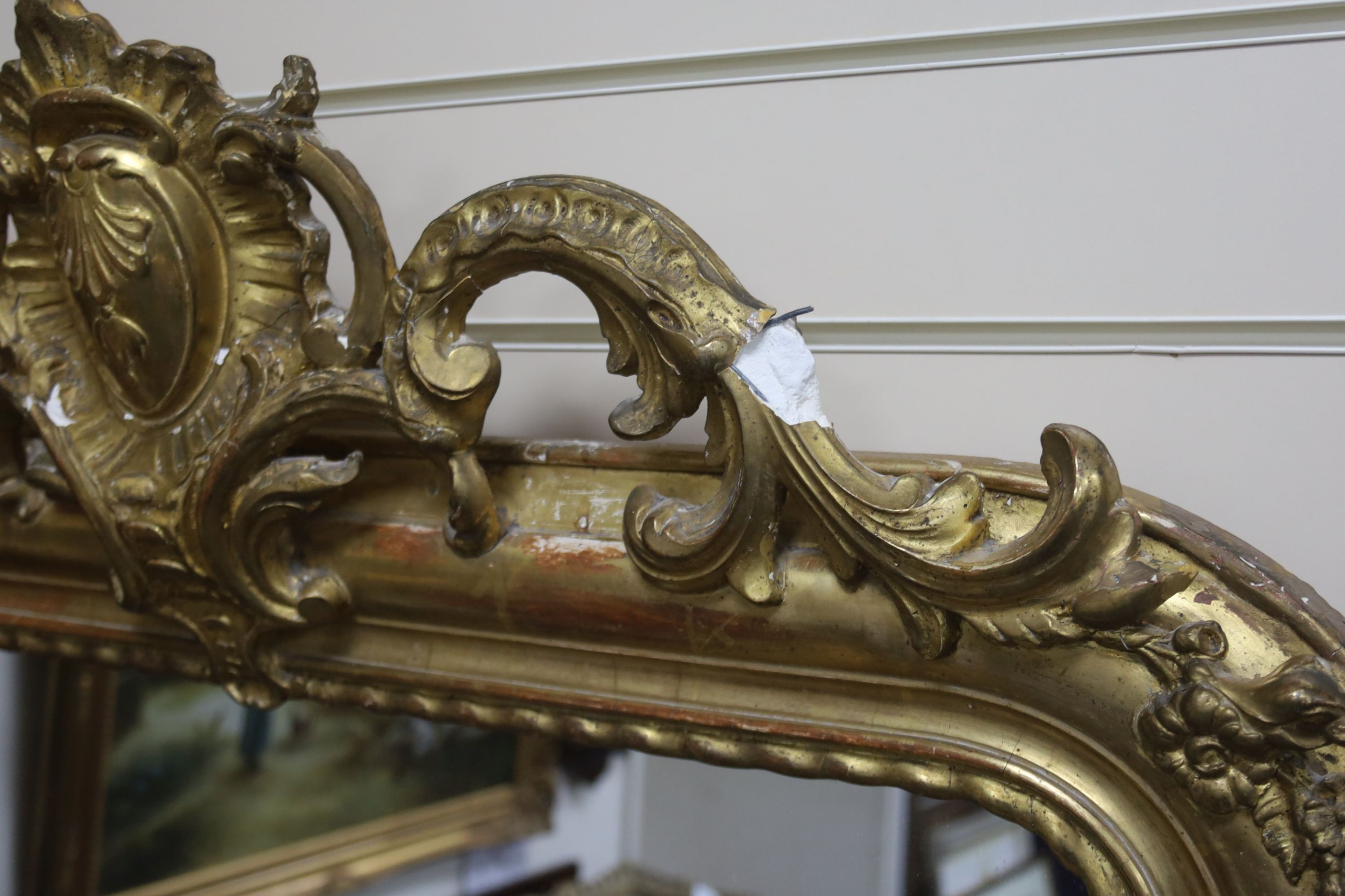 A 19th century French overmantel mirror, giltwood and gesso with channelled frame and scroll with cabochon crest detail, width 98cm, height 164cm